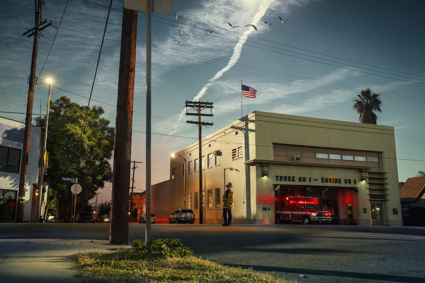 Fire station with a fire truck parked outside at dusk.
