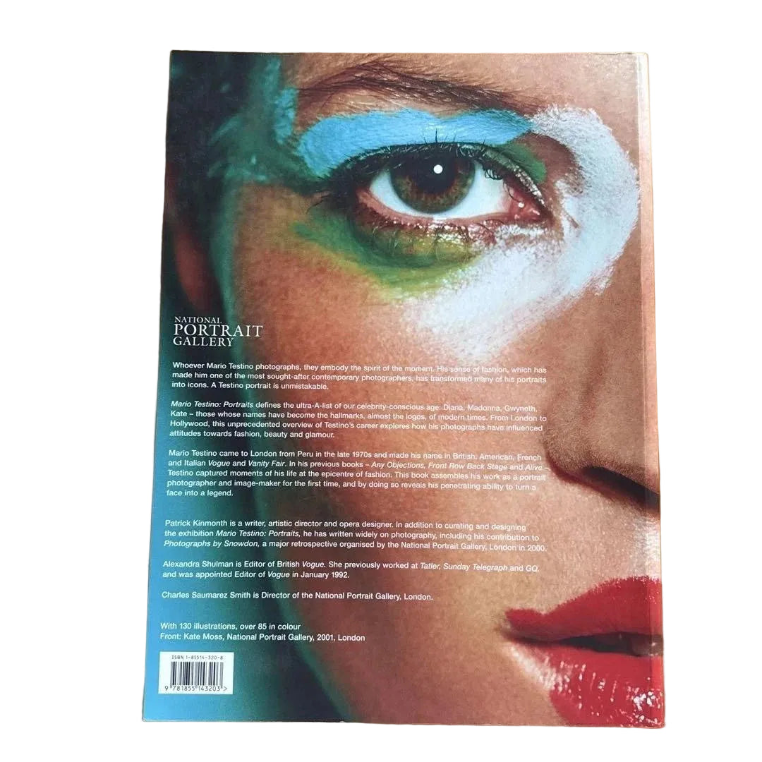 Back side of book with a colorful eye design and text on a white surface