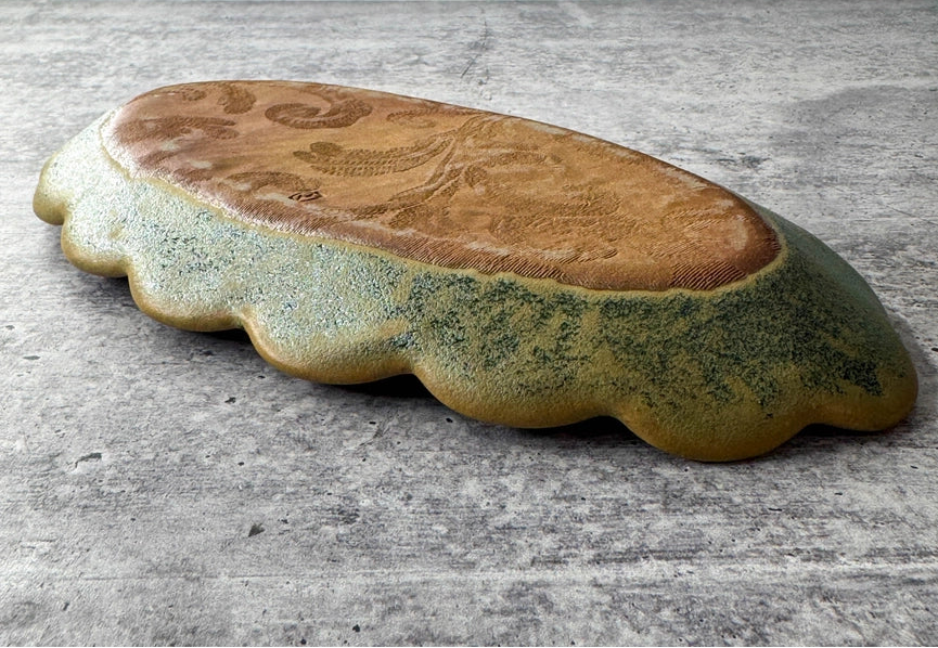oval shaped stoneware clay tray on gray background