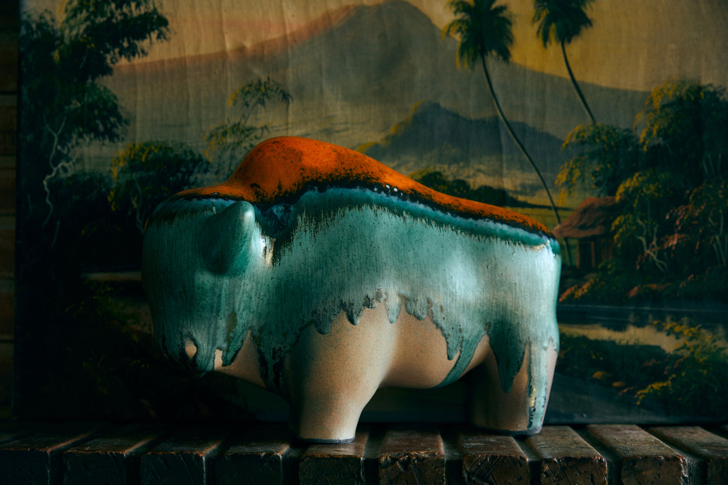 ceramic bull with orange, blue and green reactive glaze finish