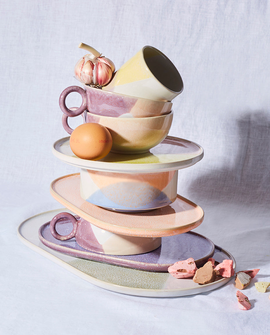 Stacked ceramic dishes with a neutral background