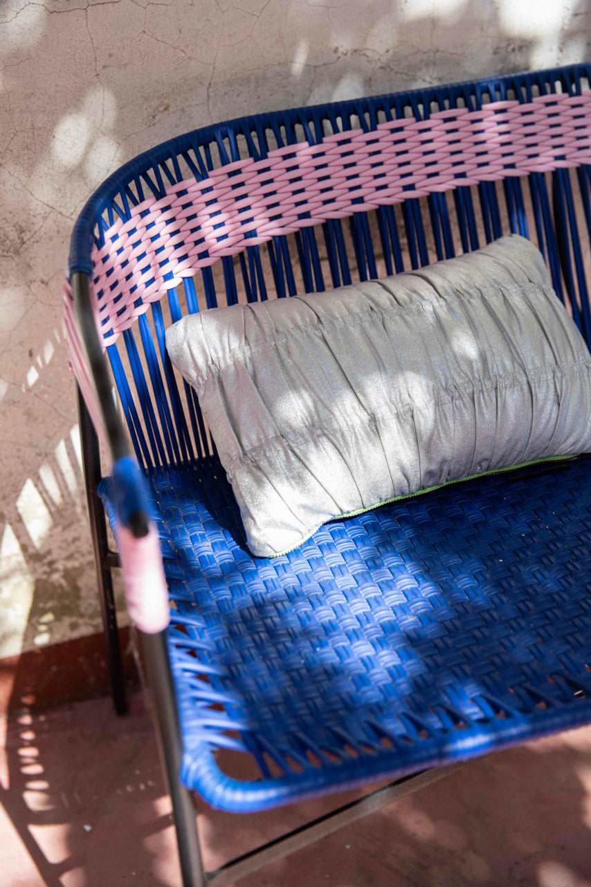 silver colored wrinkled accent pillow in blue bench