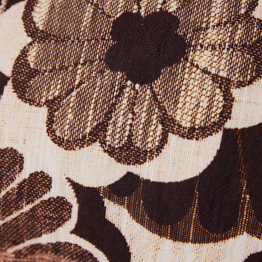 close up of fabric vintage inspired lumbar pillow with brown flowers