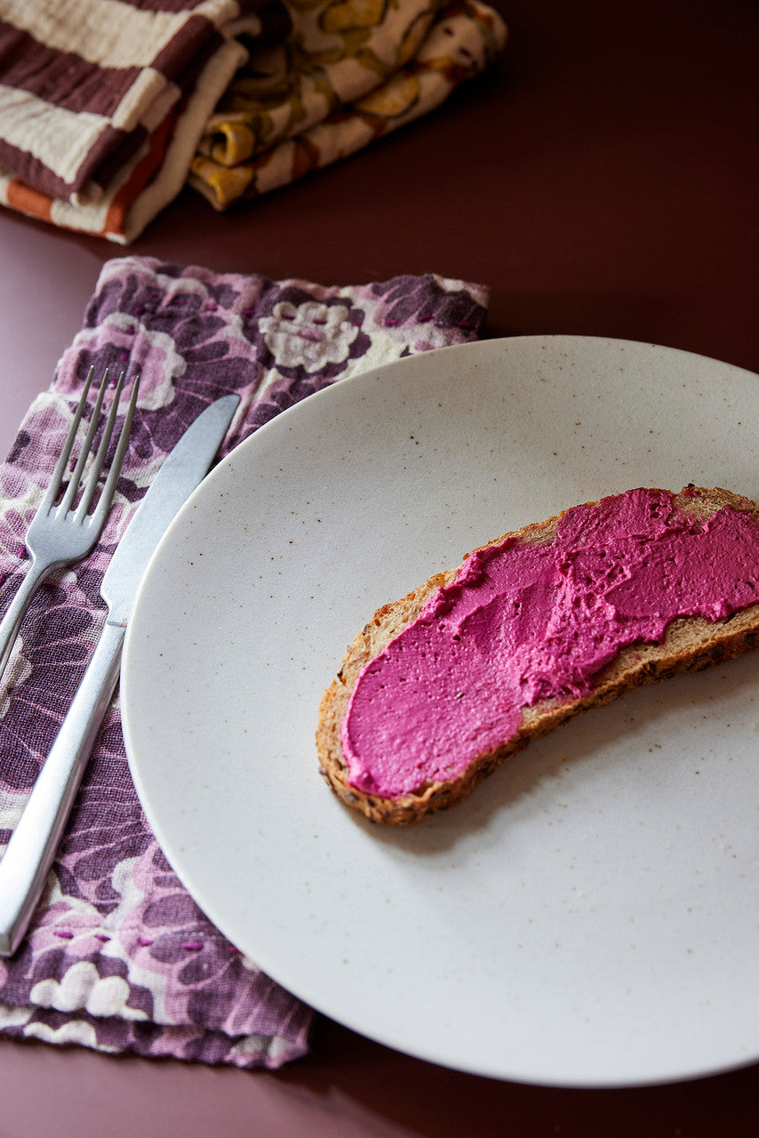 white plate, bread with spread and napkin