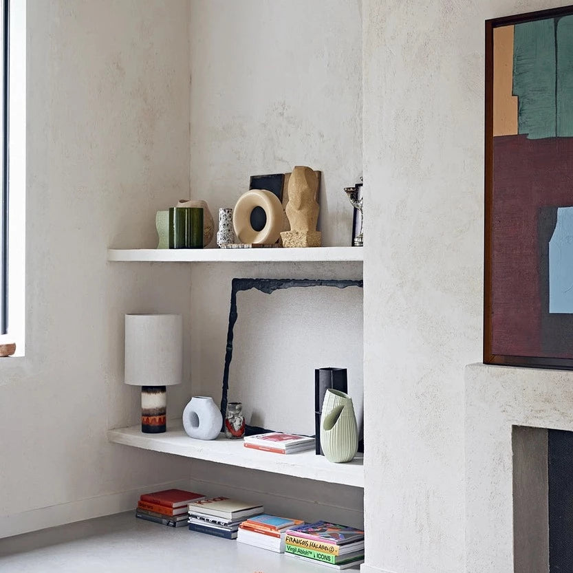 retro glazed table lamp with off white linen shade in an open shelving wall