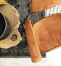 arm rest chair in brass color with terracotta color slip cover made from velvet