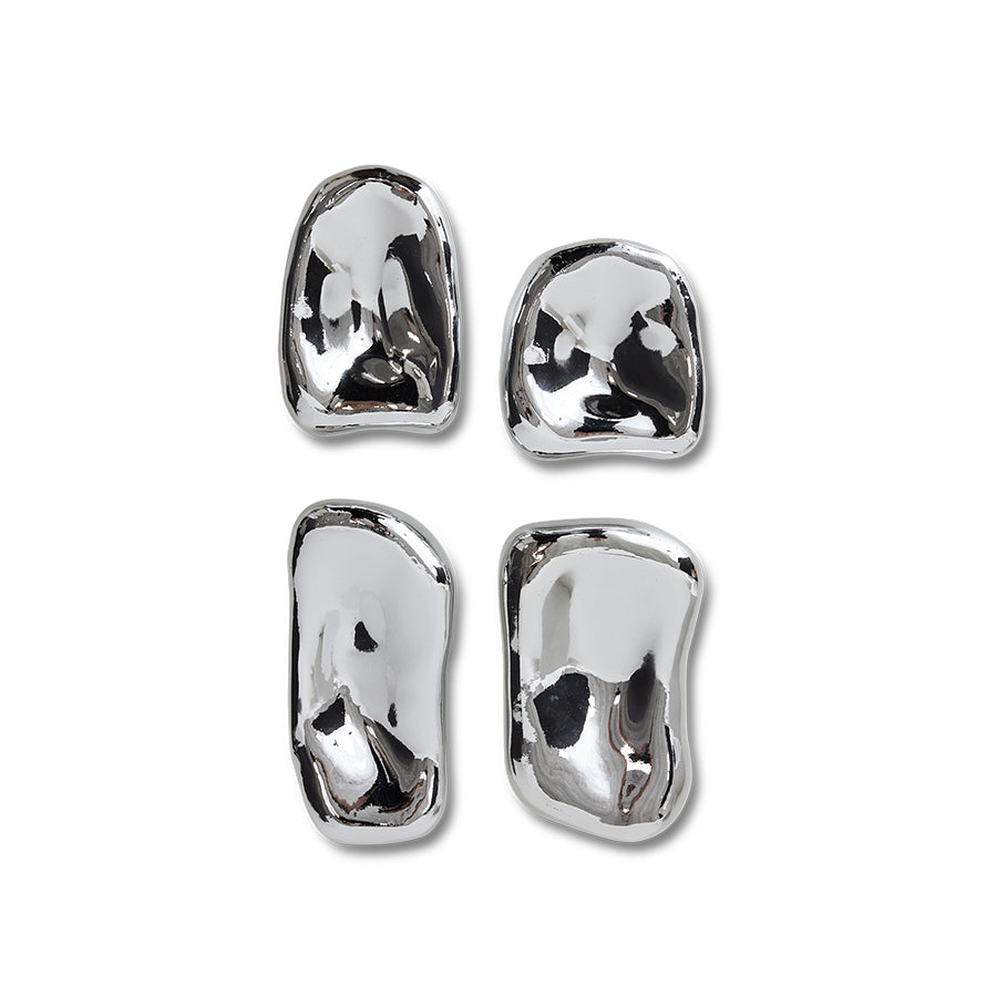 4 chrome colored organic shaped shiny objects on a white background