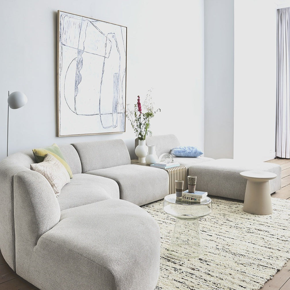 living room with white wall, light gray element sofa glass accent table and earthenware accent table