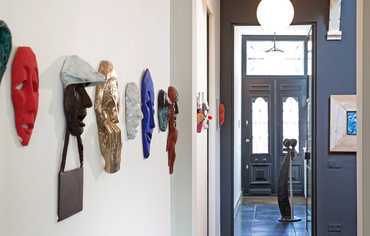 impression of group 3d sculpture in bronze on wall