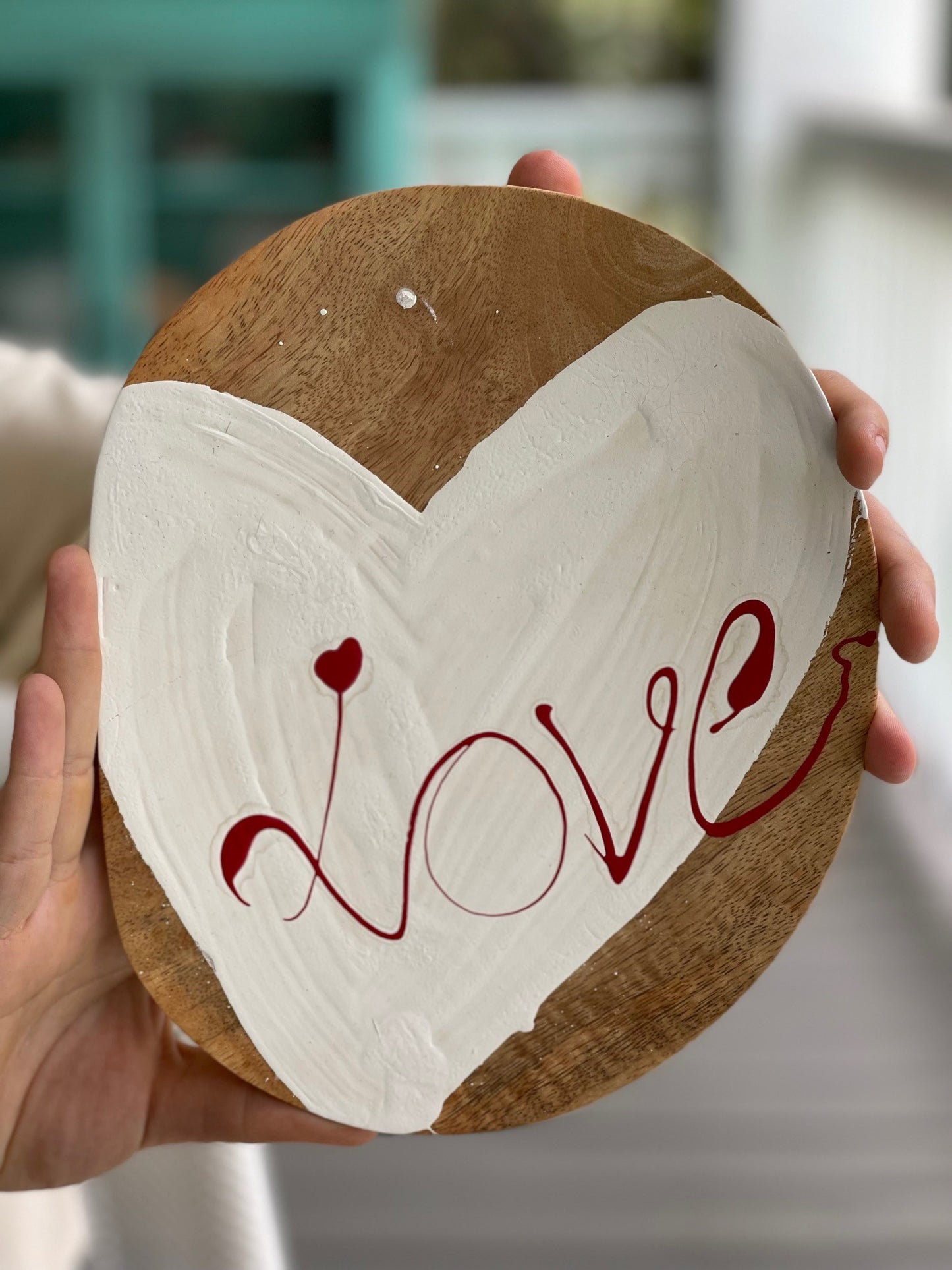 white heart with red love on a mango wood oval shaped plate