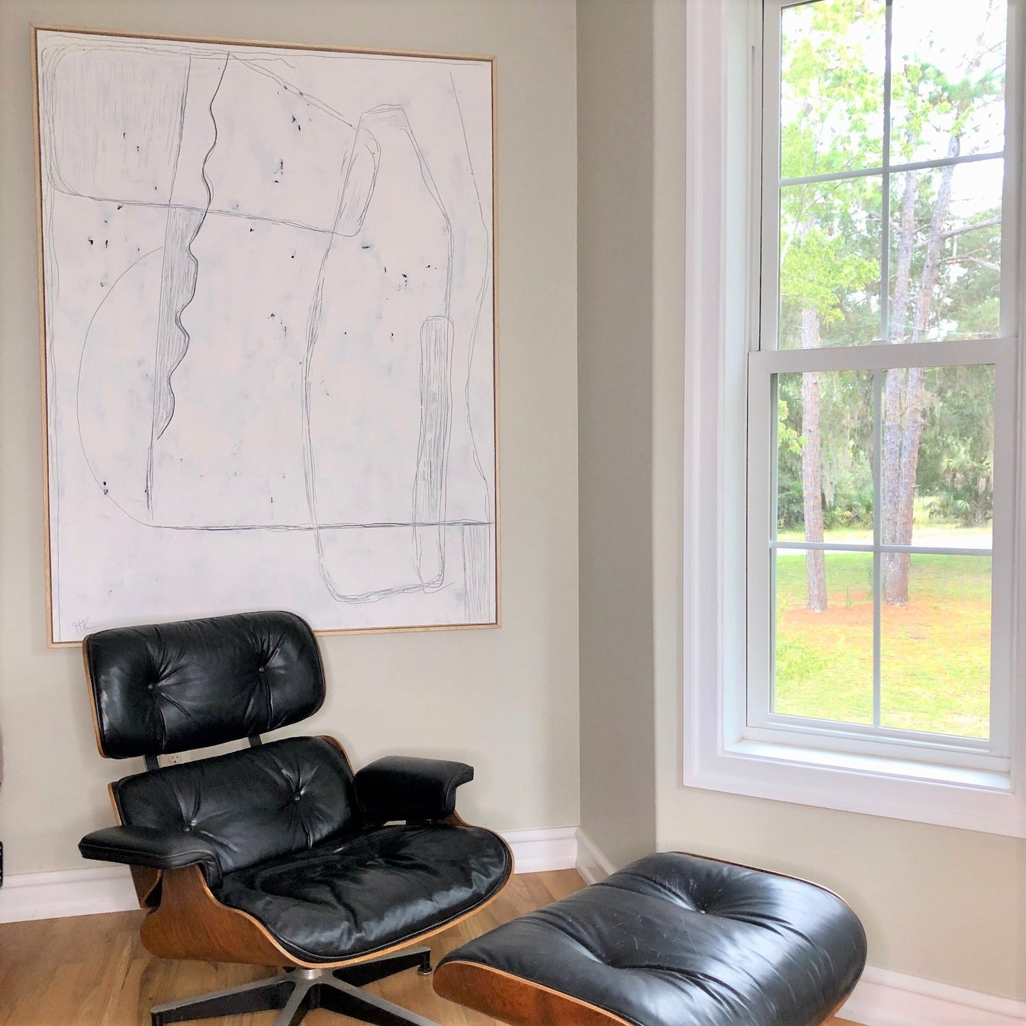 Eames chair and large white framed painting
