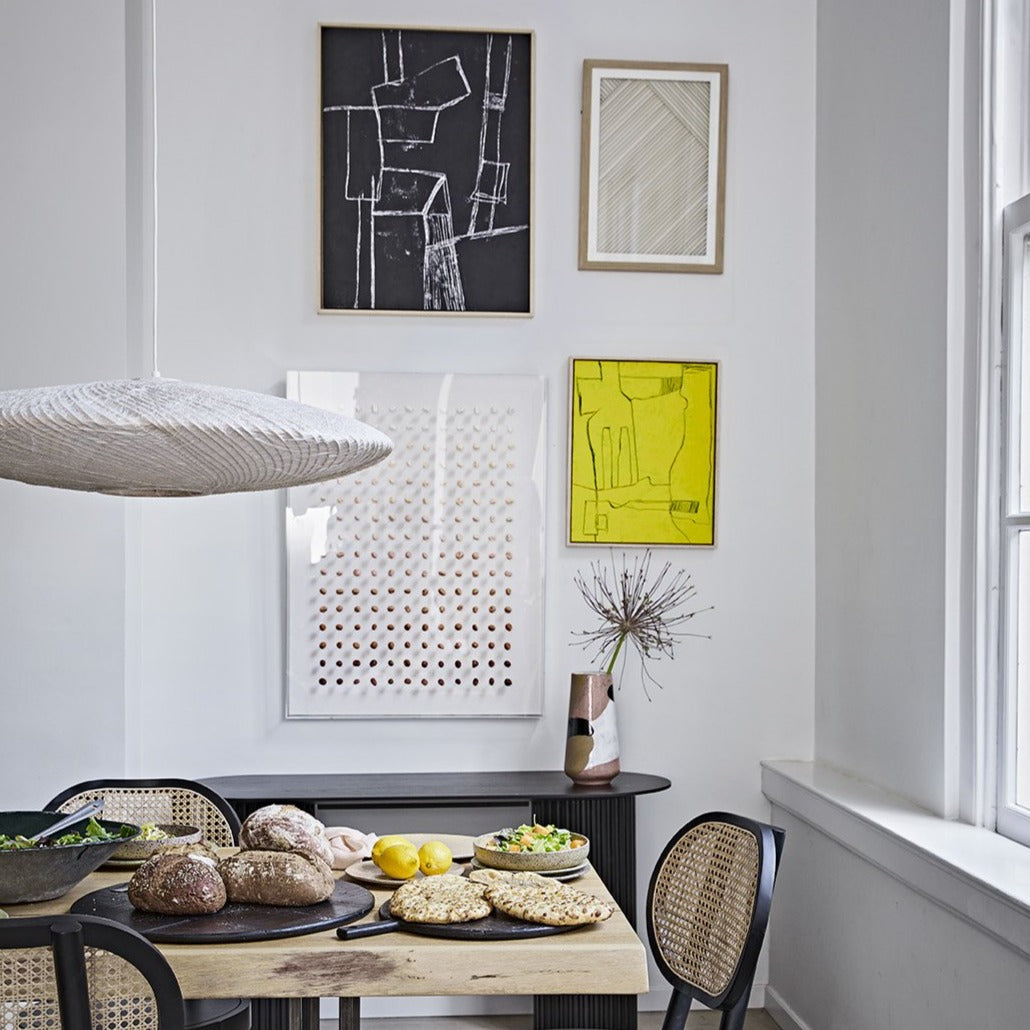 modern dining room with gallery wall with abstract art