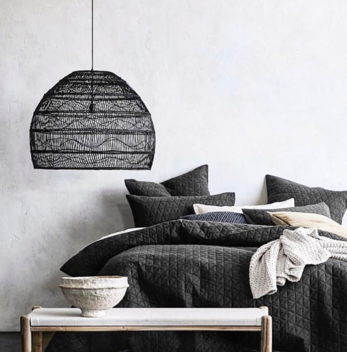 Large black wicker pendant light in bedroom