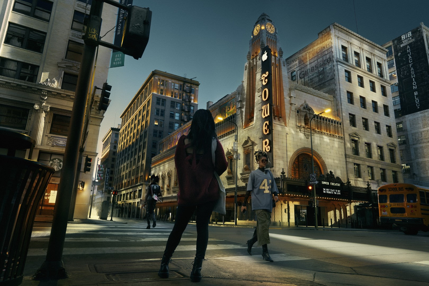 Two people walking on a city street with a prominent building labeled 'Tower' in the background.