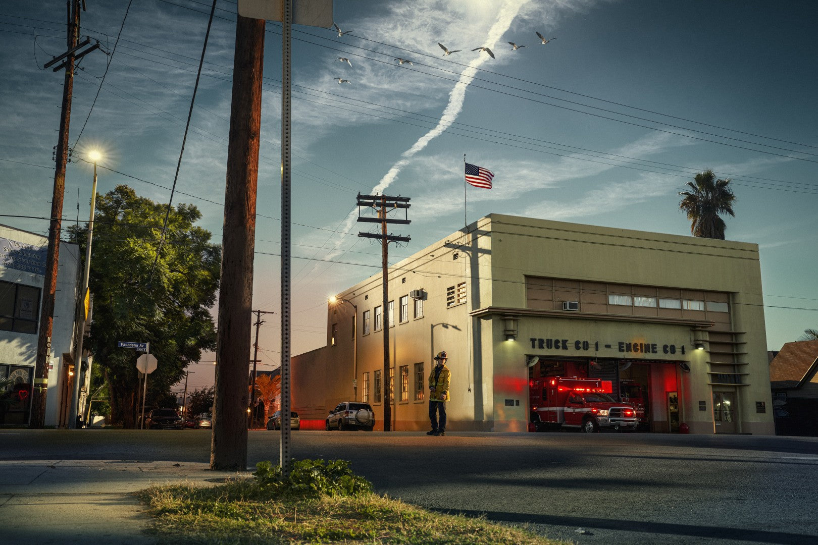 Fire station with a fire truck parked outside at dusk.