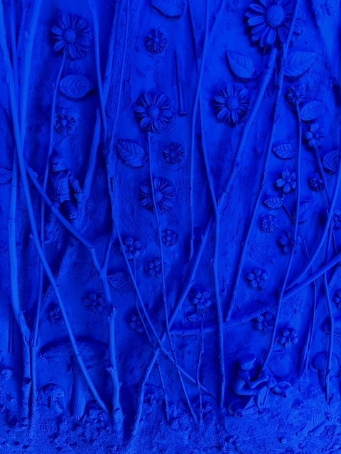 Close-up of textured blue fabric with floral patterns