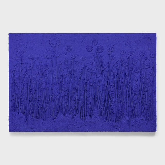 Textured blue artwork with abstract designs on a white background
