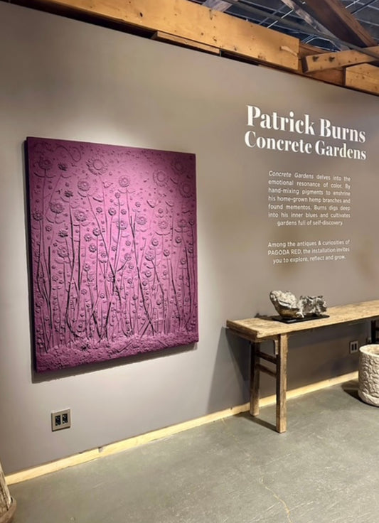 Purple textured artwork on a gray wall with 'Patrick Burns Concrete Gardens' text