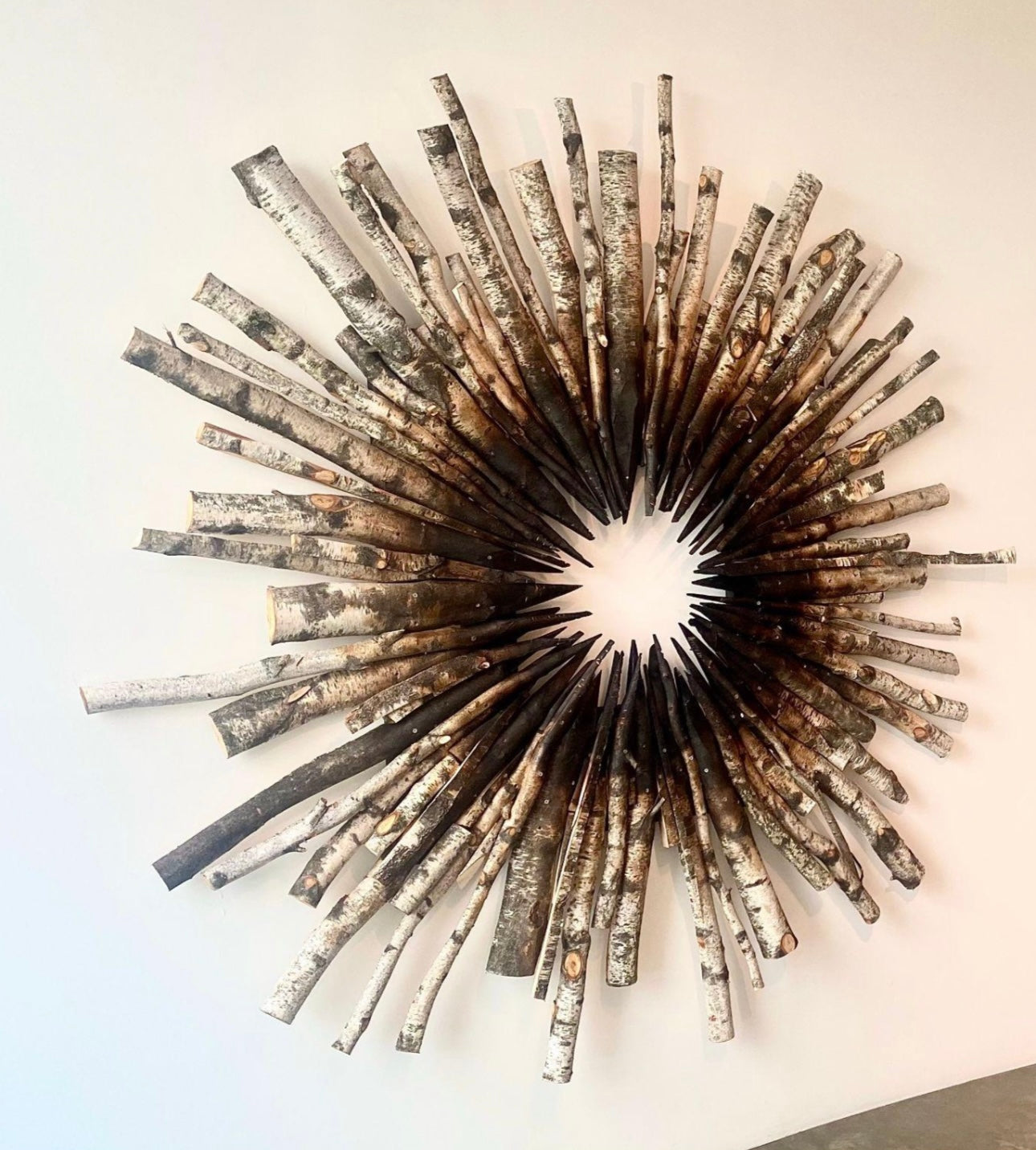 Decorative wall light fixture with sunburst design on a white wall