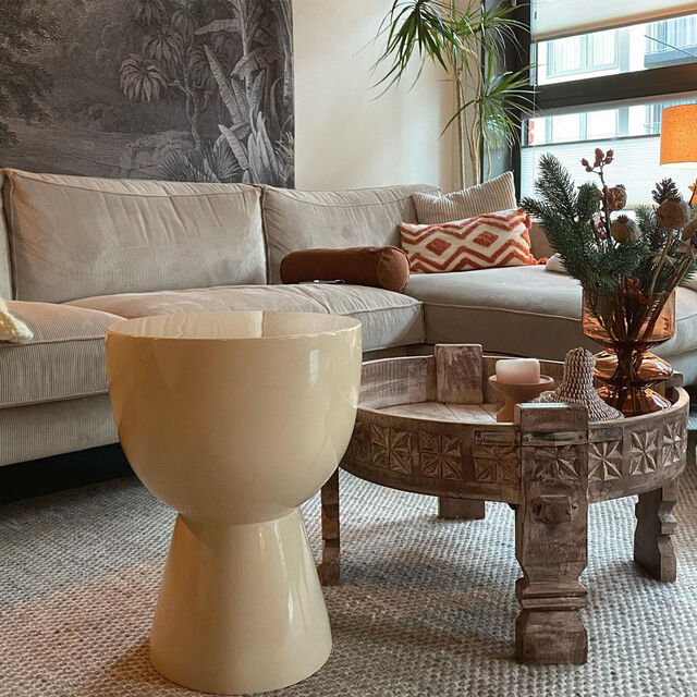 Living room with beige sofa, decorative pillows, and a wooden coffee table.
