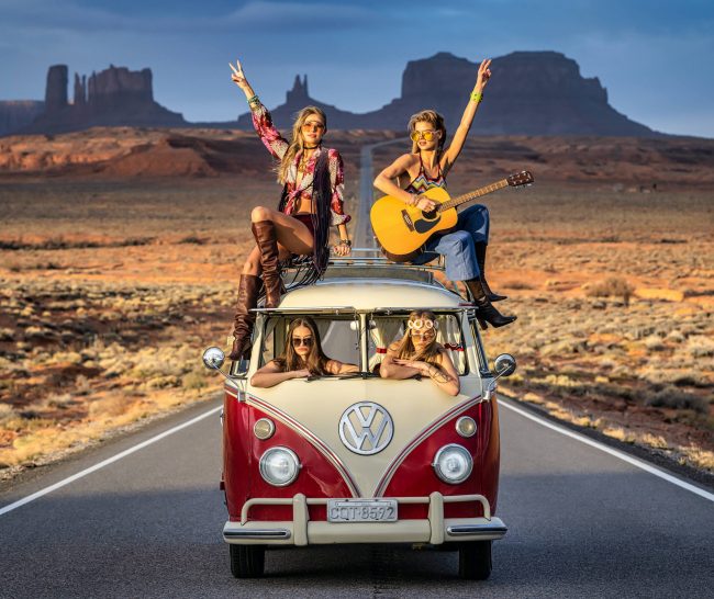 volkswagen van with 4 beautiful hippies in Monument Valley
