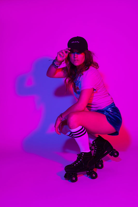 Cyan backdrop  roller blading woman with cap