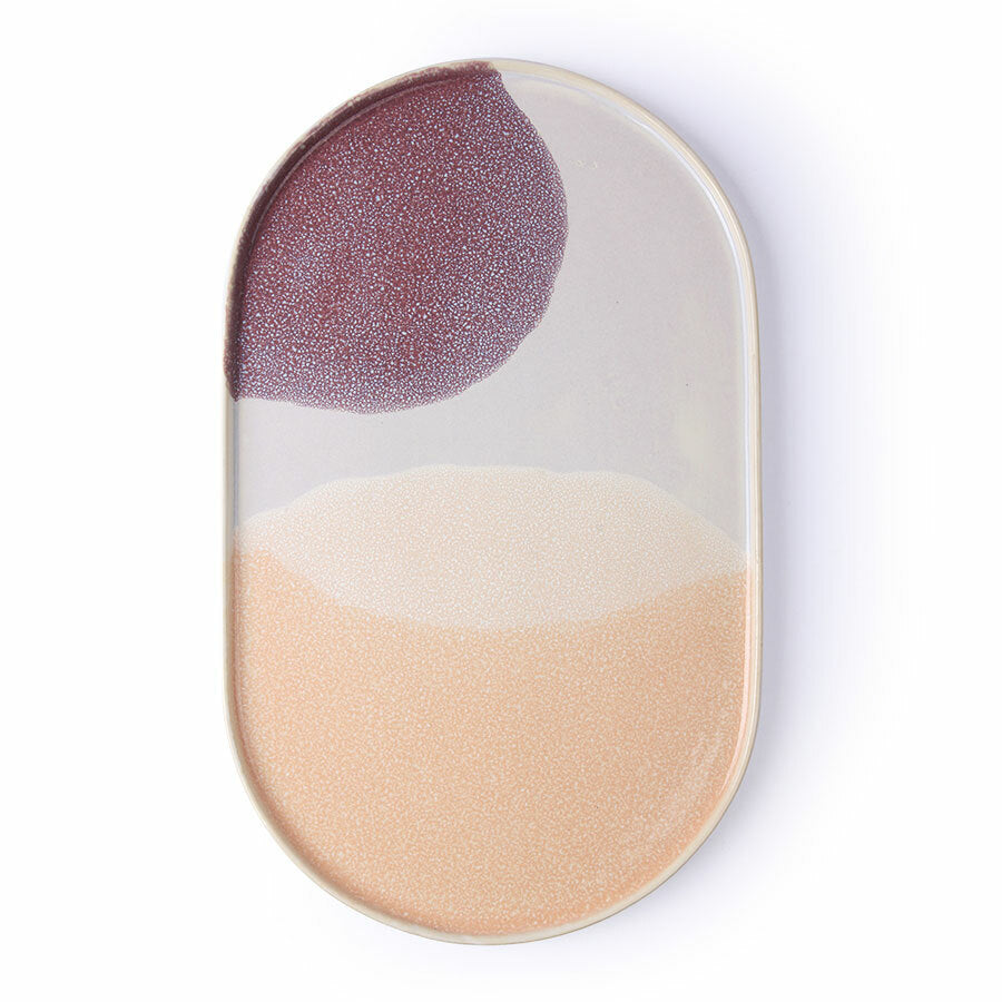 Oval ceramic plate with purple and beige design on a white background