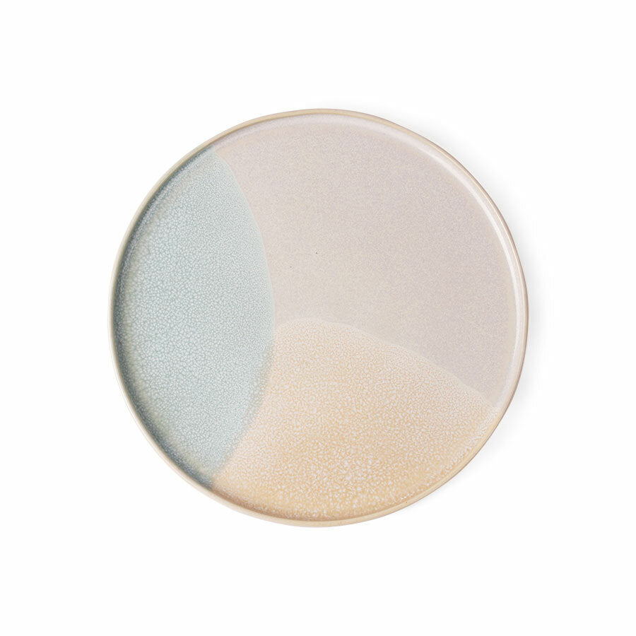 Round ceramic plate with two-tone design on a white background