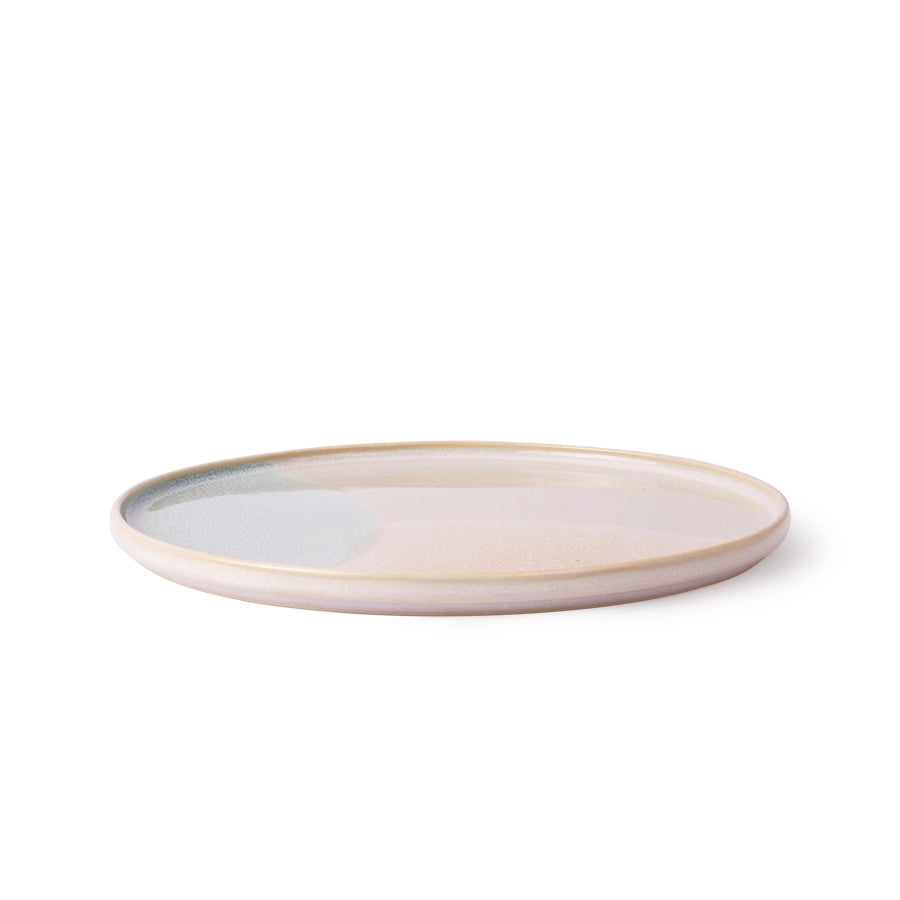Ceramic plate with a beige rim on a white background