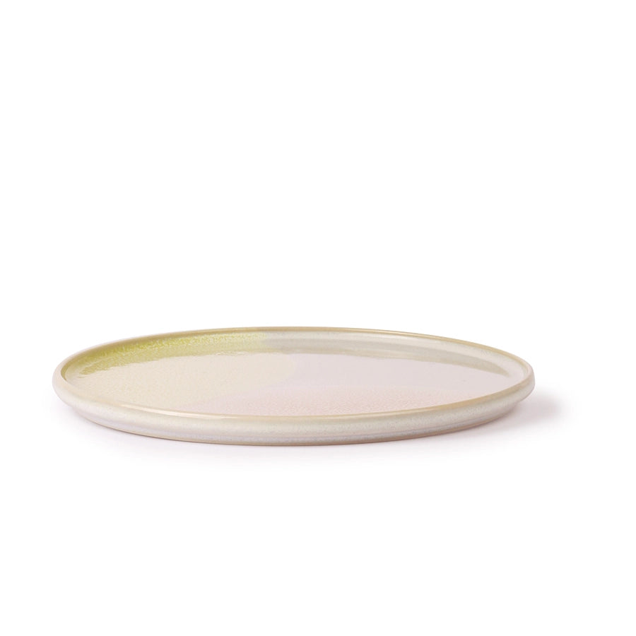Round ceramic plate with a green rim on a white background