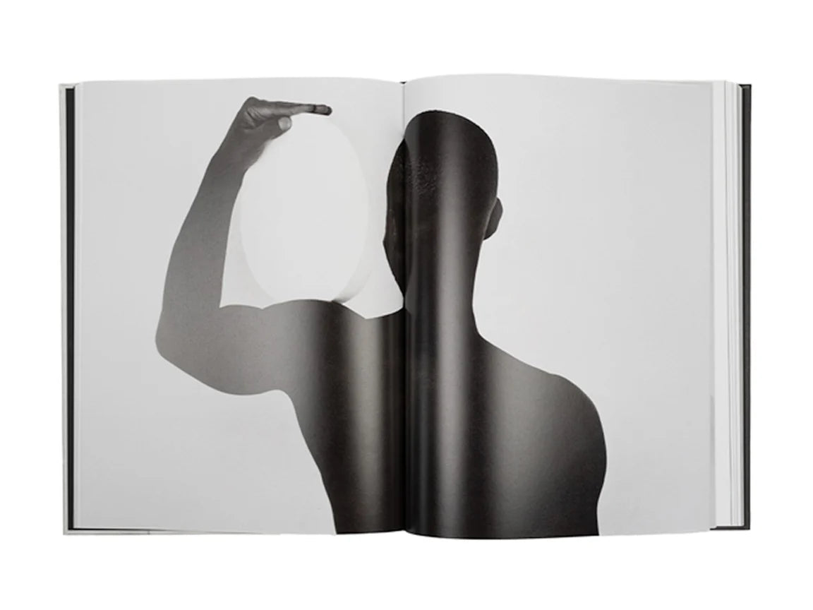 Open book showing a black and white silhouette of a person holding a light bulb.