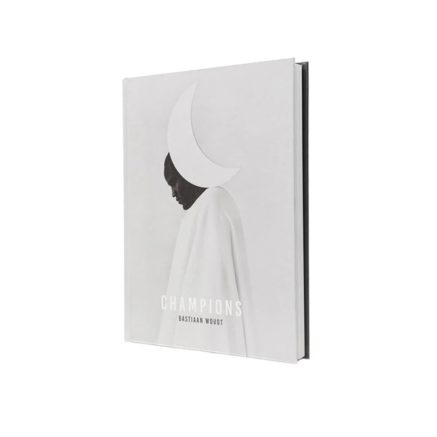 Book titled 'Champions' with a black and white design on a white background
