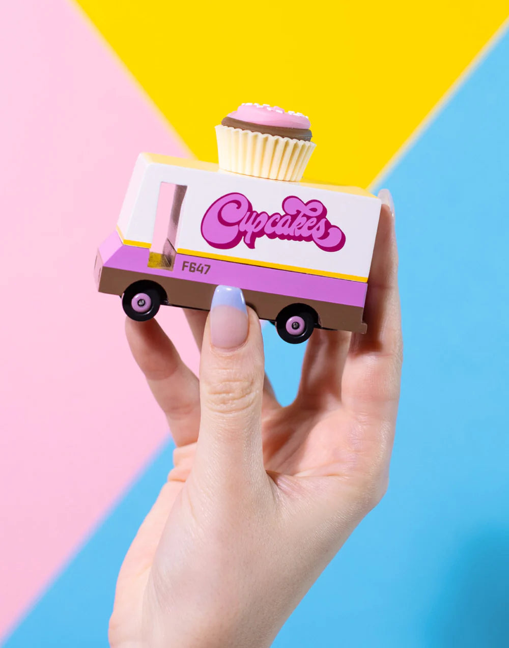 wooden cupcake food truck with blue and pink background