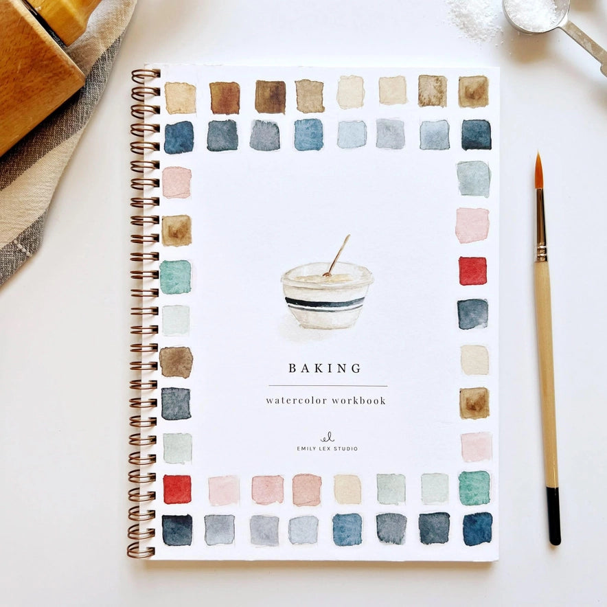 Spiral-bound notebook with watercolor design and 'Baking' text on a white surface.