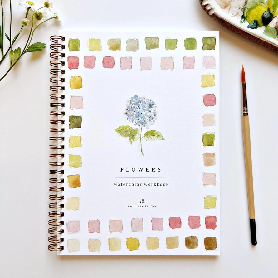 spiral book with flower and color illustrations with paintbrush on white background