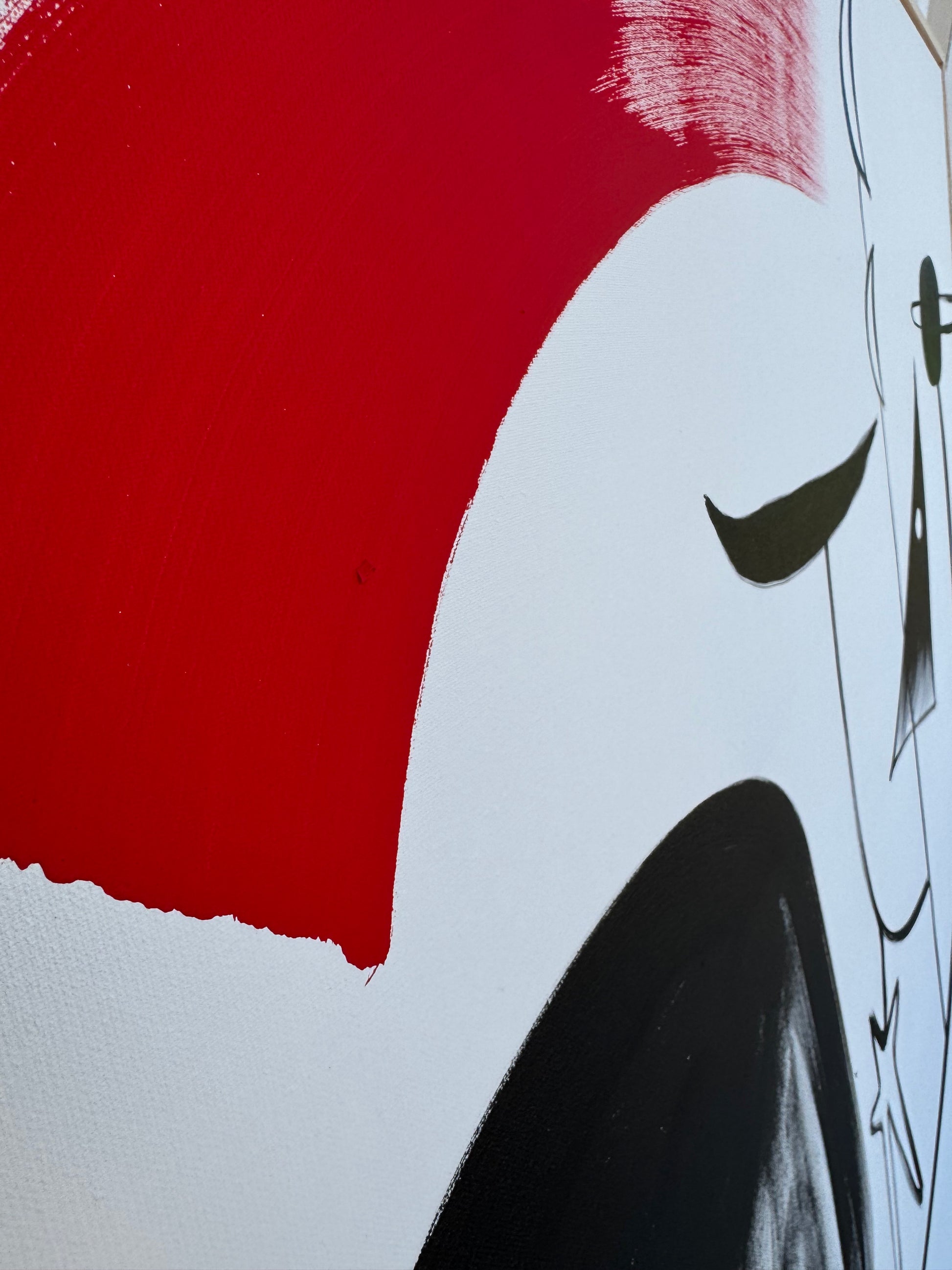 Close-up of a car with red, white, and black colors on a flat surface.