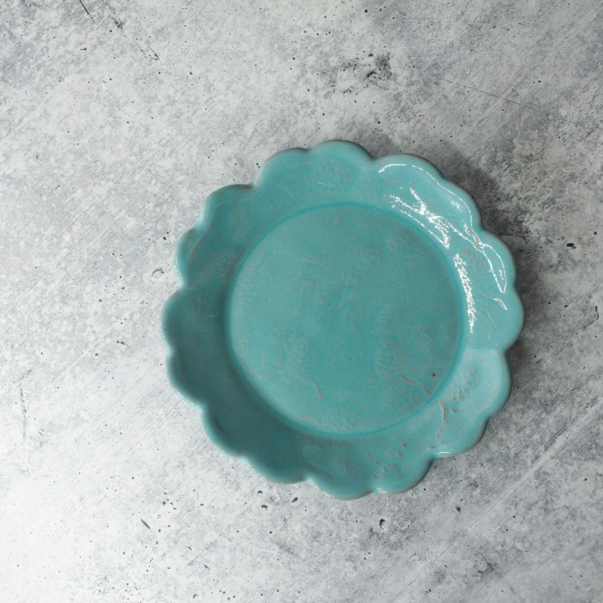 turquoise bread and butter plate scalloped edge round on gray background 