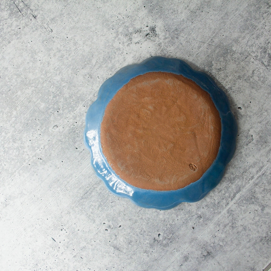 red clay blue plate on grey background