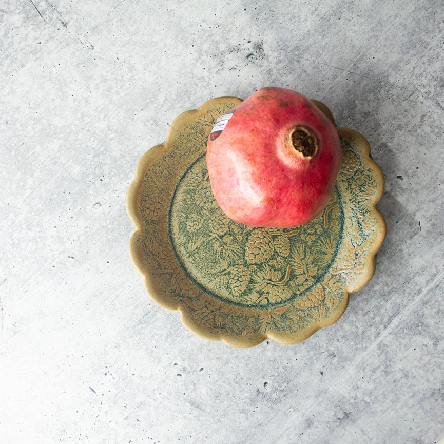 green yellow round plate with red fruit  texture on grey background