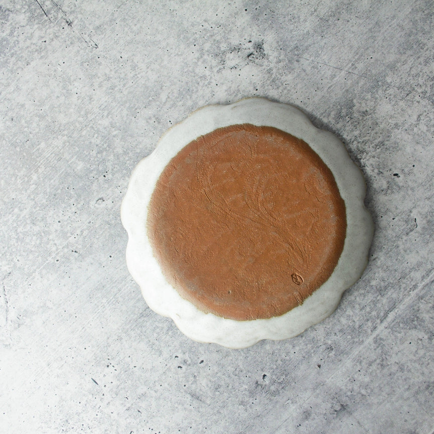 red clay beige white ceramic plate on grey background