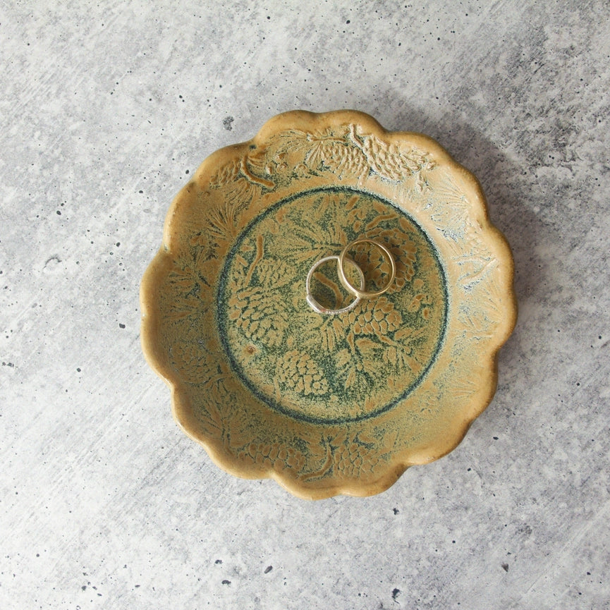 yellow and green scalloped edge plate with rings on grey background