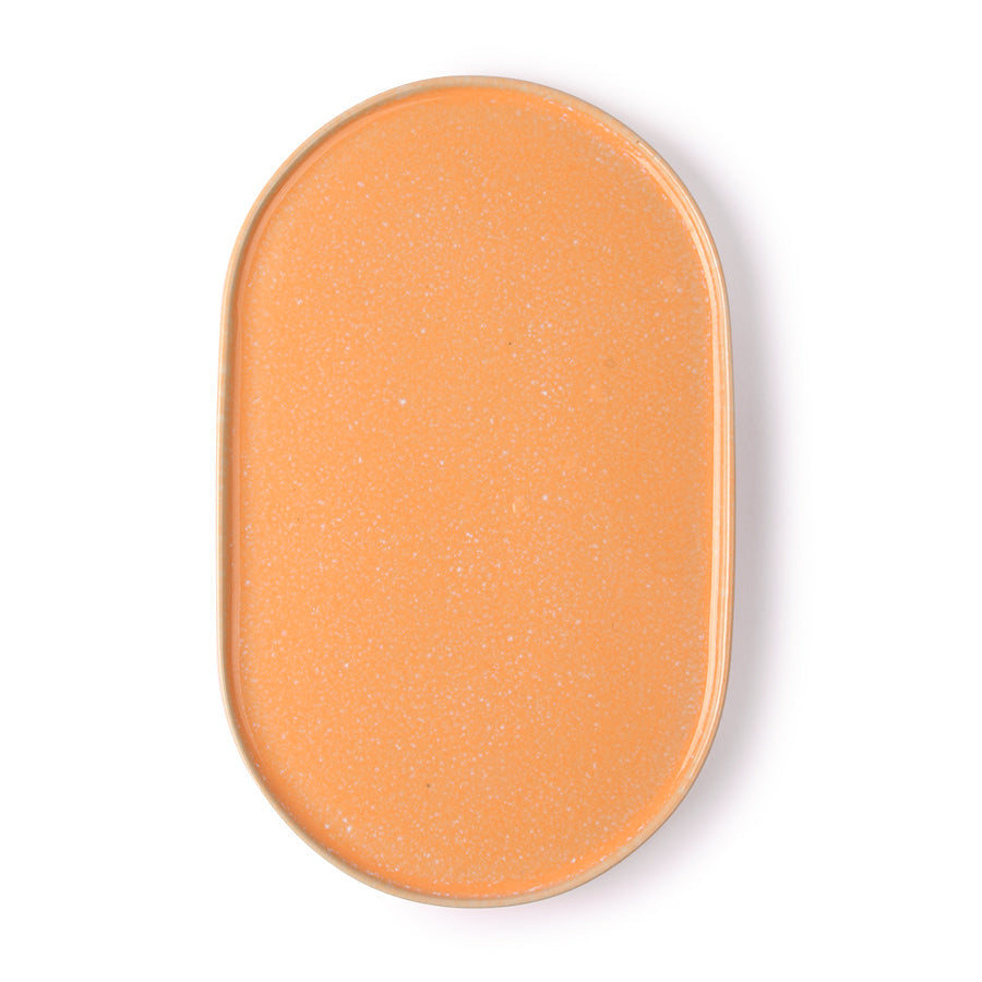 peach colored oval shaped side plate