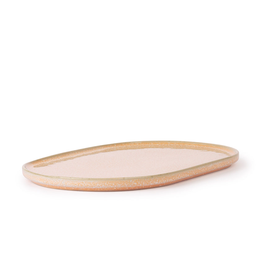 peach colored oval shaped side plate