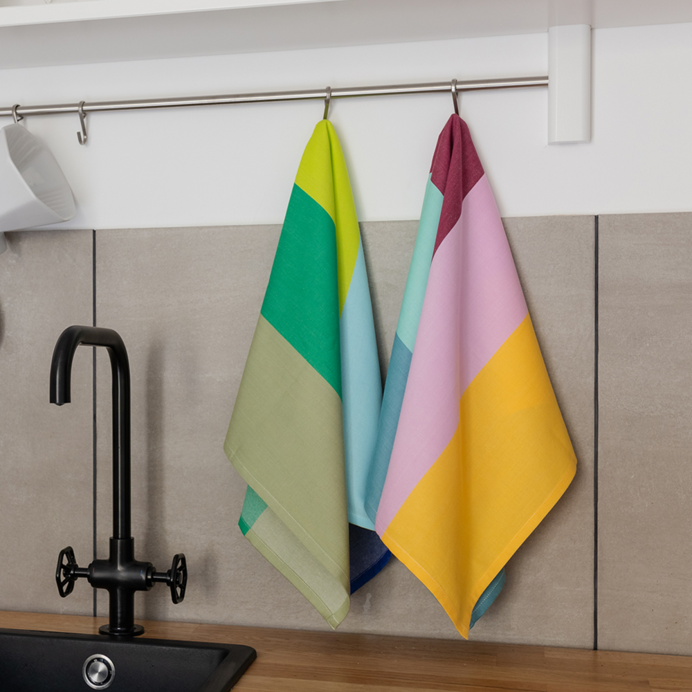 bold colored kitchen towels hanging over sink