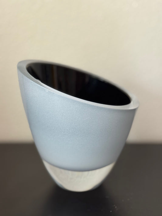 Gray cup with black interior on a beige background