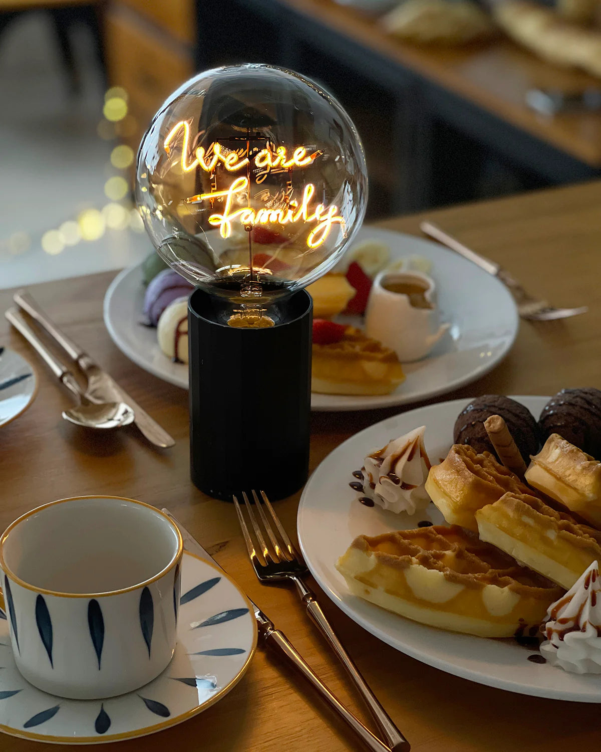 black base neon letters we are family table lamp