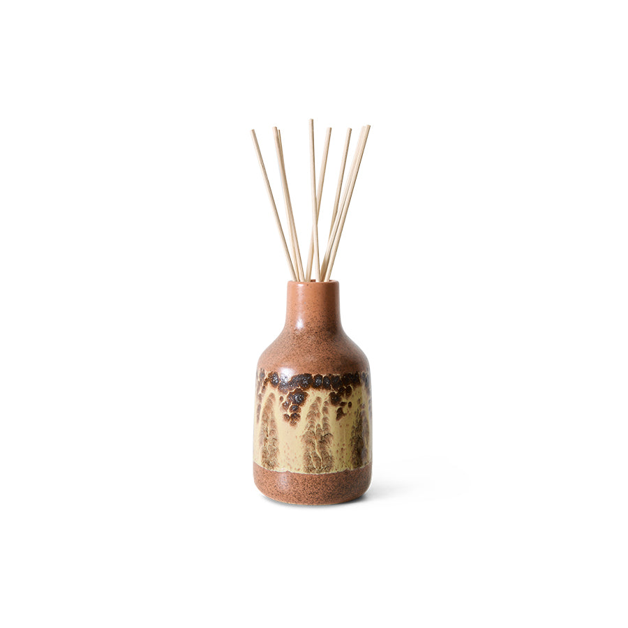 Ceramic diffuser bottle with wooden sticks on a white background
