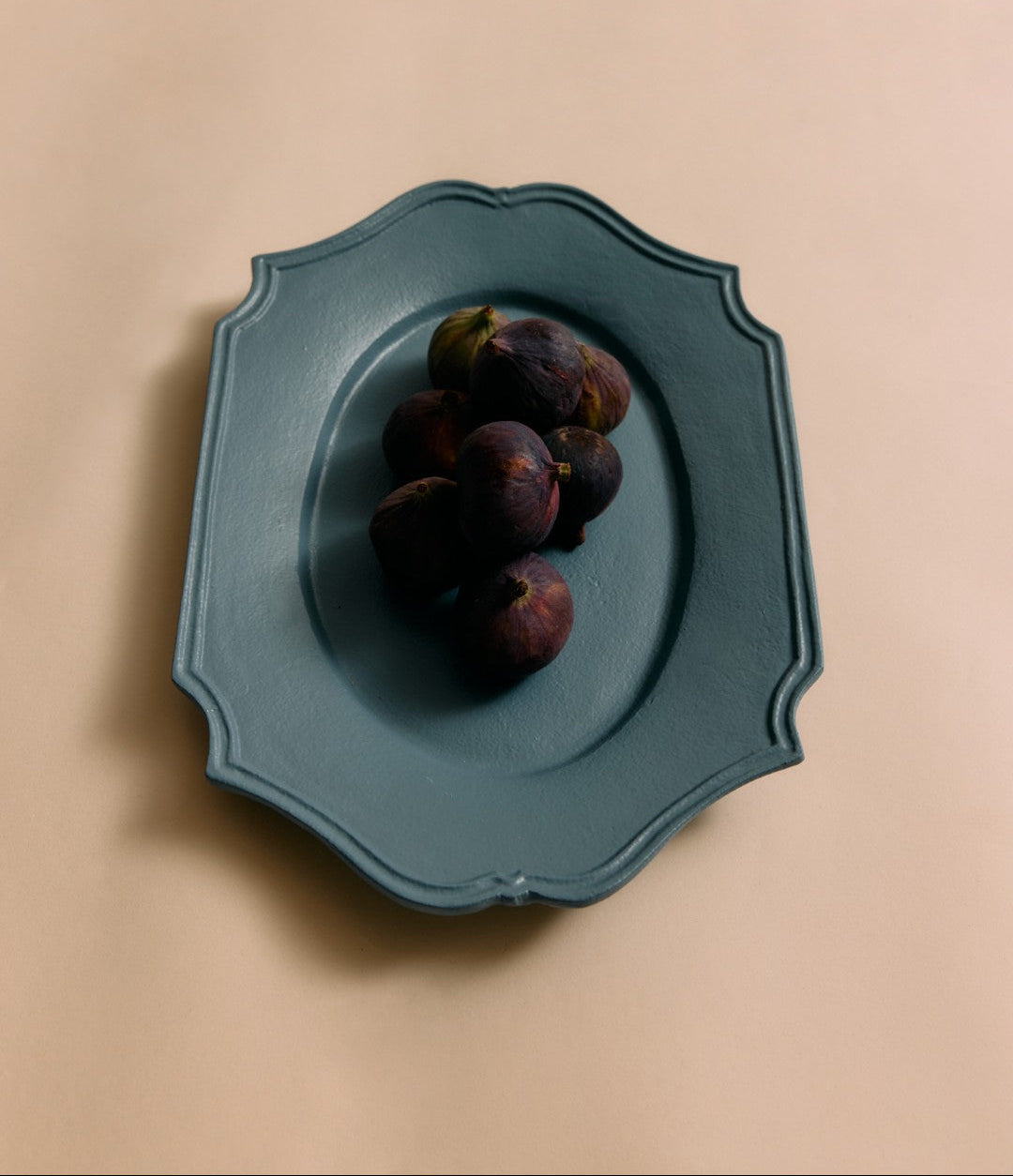 blue serving platter with figs on a blush background