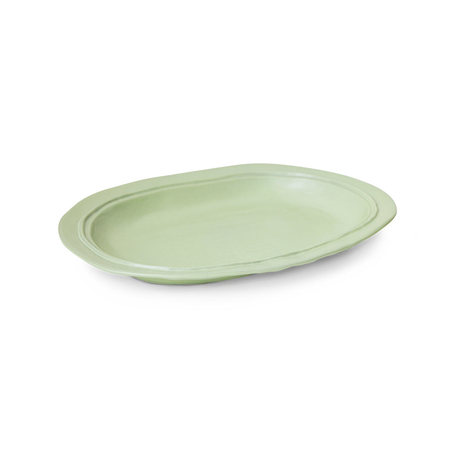 Green ceramic plate on a white background