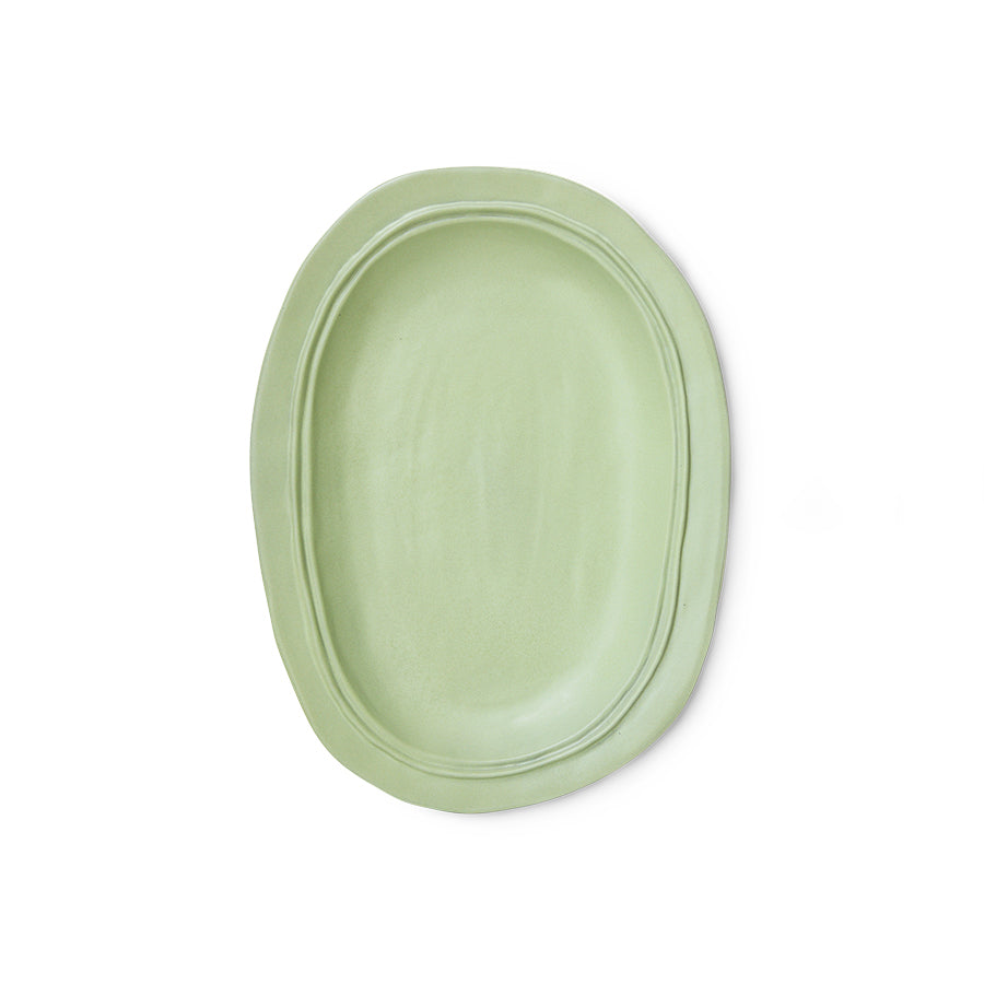 Green oval plate on a white background